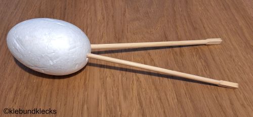 Holzstäbchen in Styropor-Ei stecken